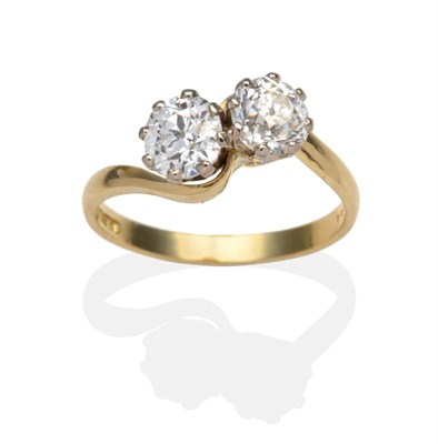 Lot 391 - An 18 Carat Gold Diamond Two Stone Twist Ring, old cut diamonds in white claw settings to...