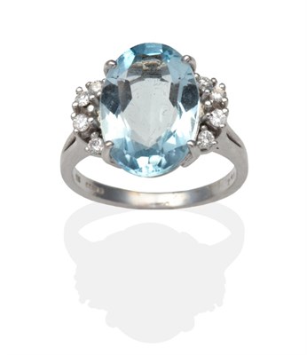 Lot 393 - A 14 Carat White Gold Aquamarine and Diamond Ring, an oval cut aquamarine in a claw setting and...