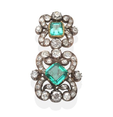 Lot 412 - An Emerald and Diamond Brooch, two graduated octagonal cut emeralds in yellow collet settings...