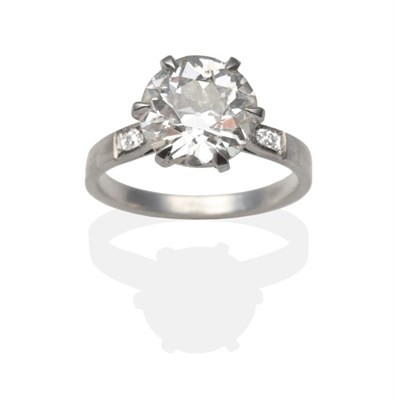 Lot 414 - A Diamond Solitaire Ring, an old cut diamond in a white claw setting, to diamond set shoulders,...