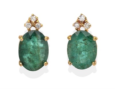 Lot 420 - A Pair of Emerald and Diamond Earrings, an oval cut emerald in a yellow claw setting topped by...