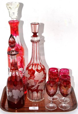 Lot 10 - Three etched cranberry glass decanters and six drinking glasses