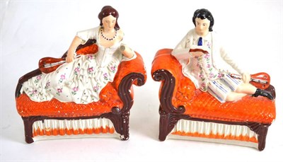 Lot 44 - A pair of seated Staffordshire figures