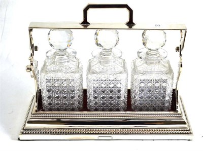 Lot 50 - A silver plated three bottle tantalus