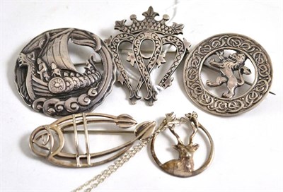 Lot 58 - A silver 'Iona' brooch, 1962, a Celtic brooch, maker 'RA', Glasgow, 1954, a Viking ship motif...
