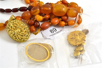 Lot 89 - An amber necklace, another necklace (part amber?), a locket and assorted jewellery
