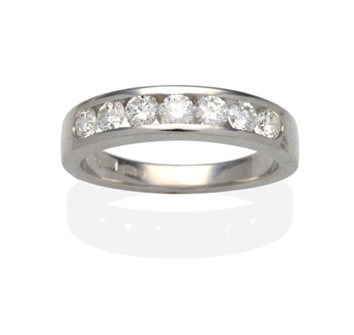 Lot 437 - A Platinum Diamond Half Hoop Ring, seven channel set round brilliant cut diamonds on a plain...