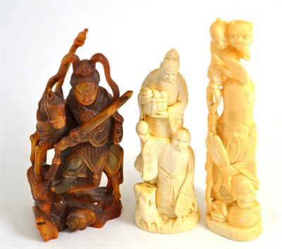Lot 97 - Two late 19th/early 20th century Japanese ivory okimonos and a resin figure (3)