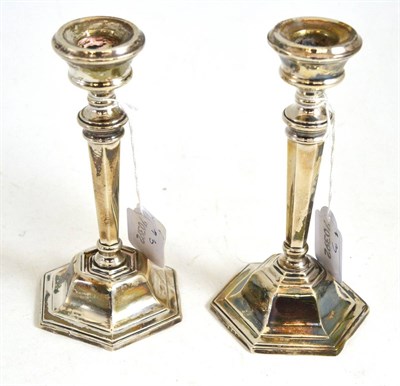 Lot 100 - Pair of loaded silver candlesticks