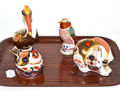 Lot 105 - Four Royal Crown Derby figures including brown pelican, a nesting gold finch, bear and a bird