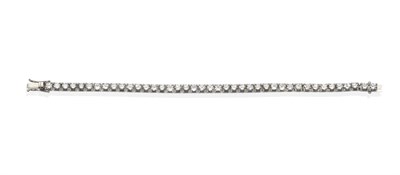 Lot 444 - A Diamond Line Bracelet, round brilliant cut diamonds in white claw settings to individual...