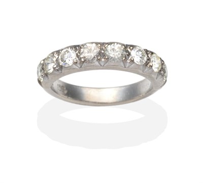 Lot 445 - A Diamond Half Hoop Ring, eight round brilliant cut diamonds in white collet and claw settings,...