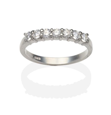 Lot 447 - A Platinum Diamond Half Hoop Ring, seven round brilliant cut diamonds in claw settings, on a...