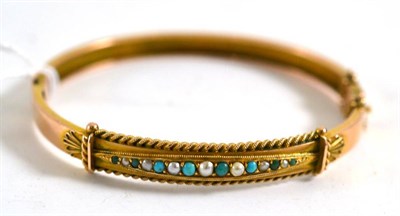 Lot 192 - A 9ct gold turquoise and seed pearl bangle, Chester 1898