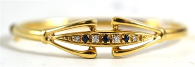 Lot 200 - A sapphire and cubic zirconia bangle, stamped '375'