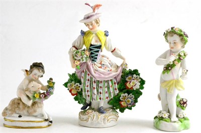 Lot 317 - A 19th century figure of a flower girl, Samson figure of a cherub and a cherub and lamp group (3)