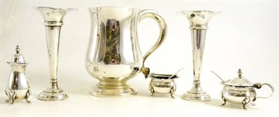 Lot 323 - A silver mug, two silver salts with blue glass liners, silver pepper and a pair of plated spill...