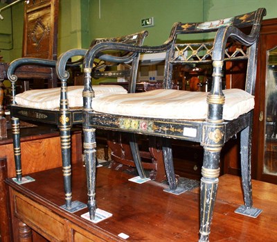 Lot 502 - Two Regency ebonised and painted elbow chairs with caned seats