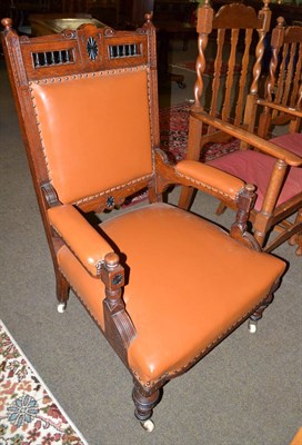 Lot 522 - Late Victorian oak framed open armchair with leather upholstery