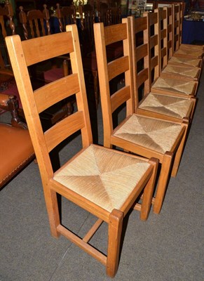 Lot 523 - Set of eight oak framed rush seated dining chairs