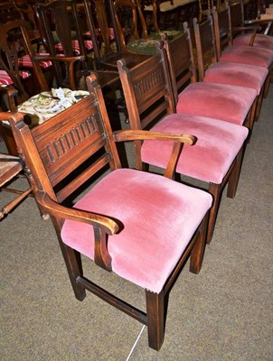 Lot 536 - A set of six oak linen fold dining chairs including two carvers