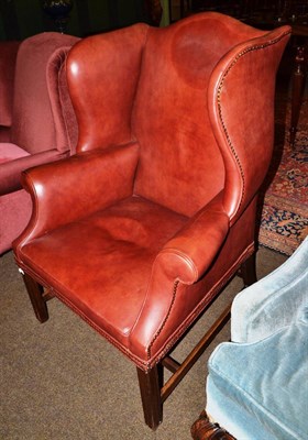 Lot 542 - Brown leather wing armchair