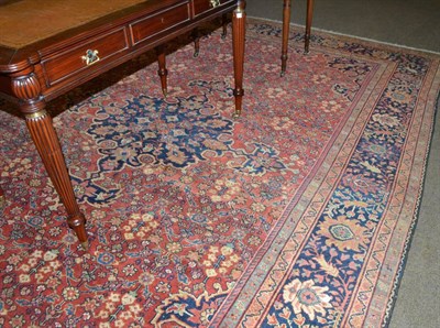 Lot 545 - Mahal carpet, West Persia, the brick red lattice field centred by an indigo medallion framed by...