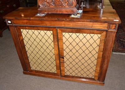 Lot 549 - Rosewood side cabinet with brass grilled doors, with key