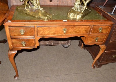 Lot 567 - A 1920's walnut desk with leather top