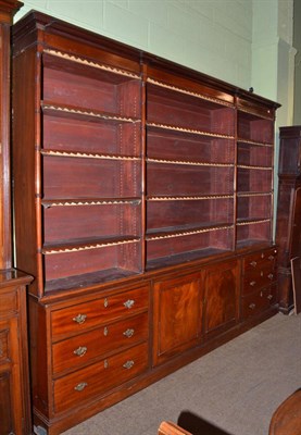 Lot 585 - A large late Victorian triple section open bookcase over drawers