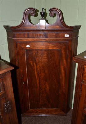 Lot 587 - A George III mahogany hanging corner cupboard