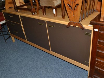 Lot 638 - A 1970's beech and brown laminate sideboard, the rectangular top over three drawers and two...