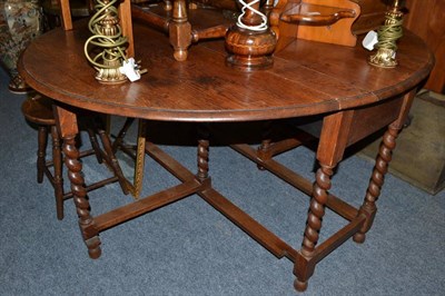 Lot 643 - An Oak drop leaf table with barley twist legs