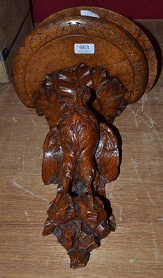 Lot 663 - Two carved oak wall brackets carved with game birds