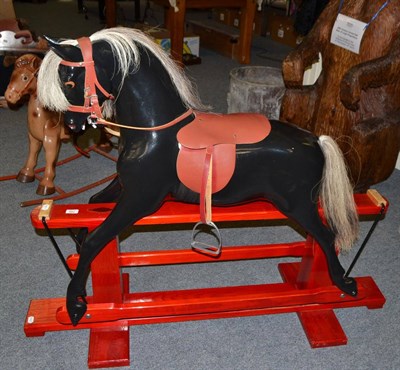 Lot 796 - Haddon Rockers black painted rocking horse on red treadle base