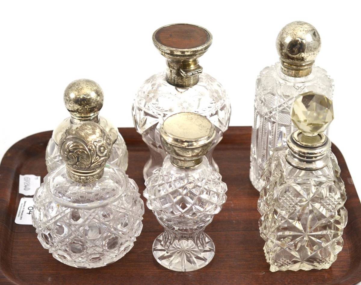 Lot 84 - Six cut glass toilet bottles with silver mounts