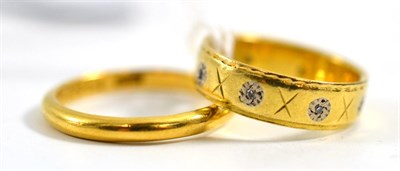 Lot 120 - A 22ct gold band ring and a diamond set ring stamped '18CT' (2)