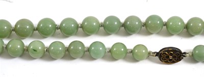 Lot 124 - A jade type bead necklace with silver clasp