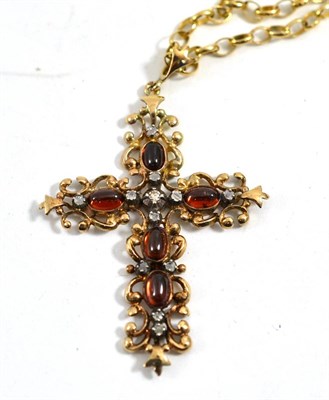 Lot 130 - A garnet and diamond set cross pendant on chain