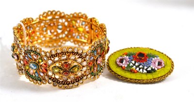 Lot 145 - Gilt metal bangle set with coloured stones and a brooch