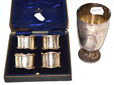 Lot 170 - A Victorian silver goblet and four napkin rings, cased