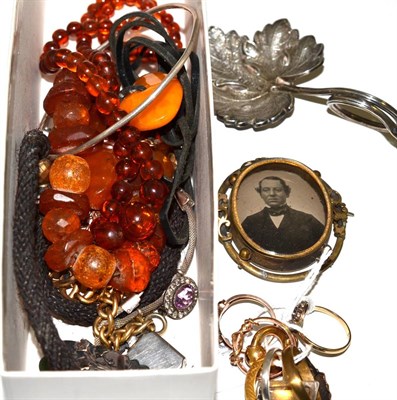 Lot 265 - An amber bracelet and two pieces of amber on a strip of leather, a 22ct gold band ring and five...