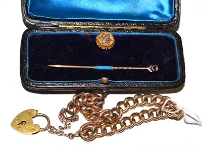 Lot 273 - A 9ct gold curb and lock bracelet and a cased diamond set stud/stick pin