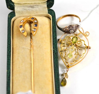 Lot 432 - A peridot and seed pearl brooch, a sapphire and diamond horseshoe pin (cased) and a ring (3)