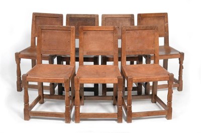 Lot 583 - A Set of Seven Robert  "Mouseman " Thompson Panel Back Oak Dining Chairs, with slung leather...