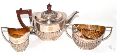 Lot 496 - A three piece silver tea set and a pair of tongs