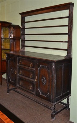 Lot 521 - A circa 1930's oak sideboard with a stained pine plate rack