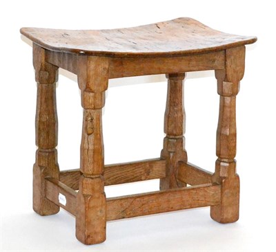 Lot 588 - A Robert  "Mouseman " Thompson Burr Oak Dish Topped Stool, the adzed top on four octagonal legs...