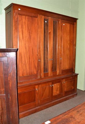 Lot 539 - Large mahogany triple wardrobe with glazed doors to the centre