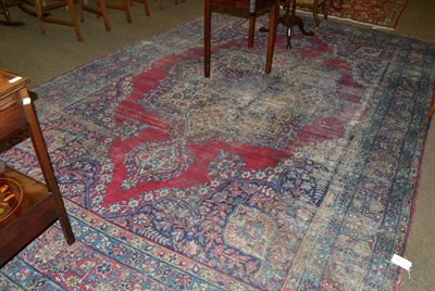 Lot 568 - Yazd Carpet, SE Persia, the plain raspberry field centred by a floral medallion framed by spandrels